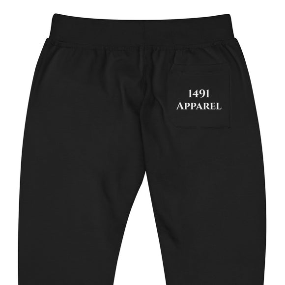 close up back view of black joggers with White curve lake lettering on front lower legs and white 1491 Apparel on the back pocket