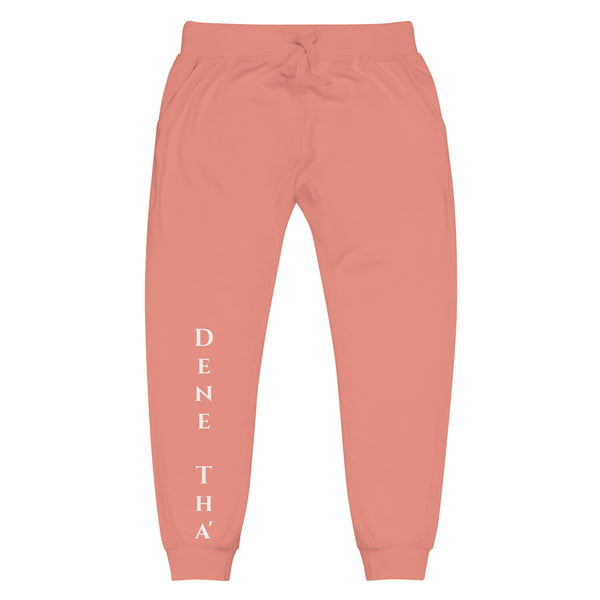Front view of dusty rose joggers with White dene tha' lettering on front lower legs and white 1491 Apparel on the back pocket