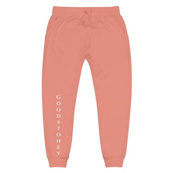 Front view of dusty rose joggers with goodstoney lettering on front lower legs and white 1491 Apparel on the back pocket