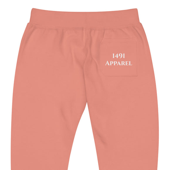 close up back view of dusty rose joggers with White goodstoney lettering on front lower legs and white 1491 Apparel on the back pocket