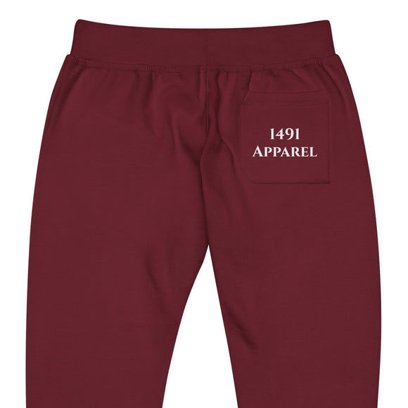 close up back view of maroon joggers with White kainai lettering on front lower right leg and white 1491 Apparel on the back pocket